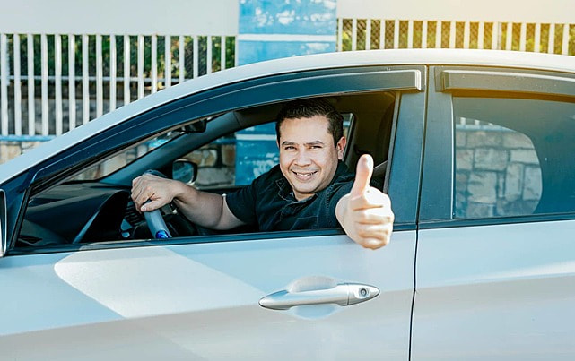 pngtree-happy-driver-giving-thumbs-up-while-driving-safely-photo-image_50019264.jpg